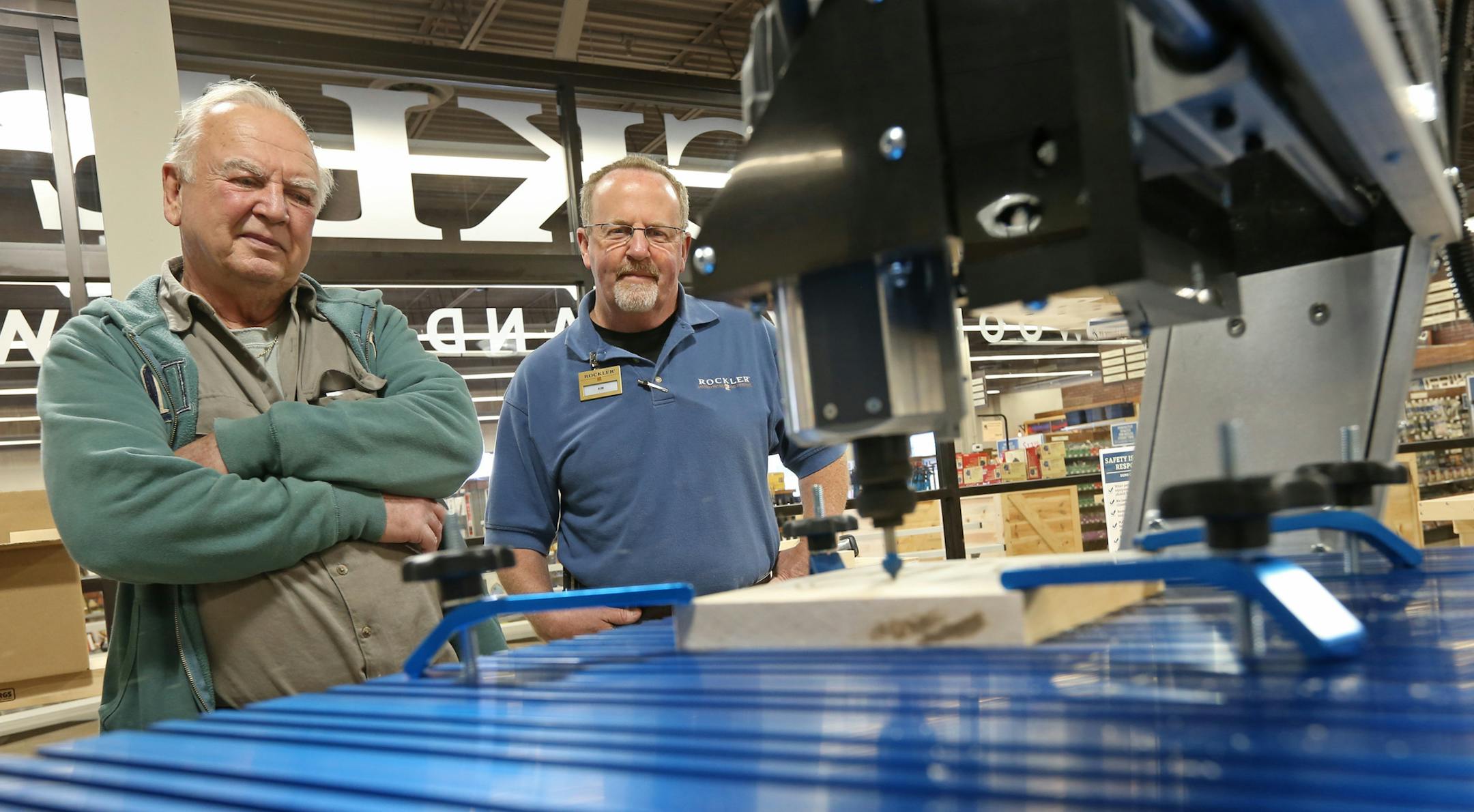 Customer Craig Thaemert of Hugo, left, and Rockler store manager Kim Rothlisberger watched a CNC cutting machine demonstration put on by employee Dave Wallace at the new Maplewood store last week. Rockler Woodworking and Hardware’s grand opening in Maplewood will be on Saturday.