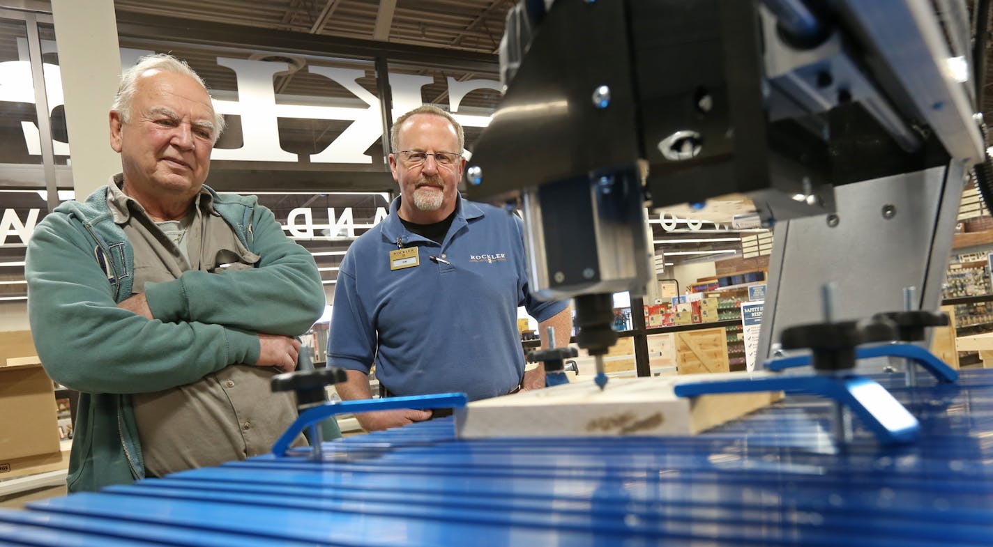 Customer Craig Thaemert of Hugo, left, and Rockler store manager Kim Rothlisberger watched a CNC cutting machine demonstration put on by employee Dave Wallace at the new Maplewood store last week. Rockler Woodworking and Hardware&#x2019;s grand opening in Maplewood will be on Saturday.