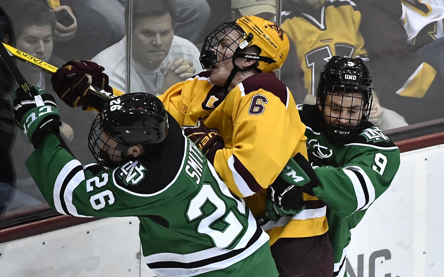 Minnesota Golden Gophers right defender Ryan Collins (6) took a hard check from North Dakota Fighting Hawks forward Cole Smith (26) and defenseman Dixon Bowen (9) in the first period Saturday. ] (AARON LAVINSKY/STAR TRIBUNE) aaron.lavinsky@startribune.com The University of Minnesota Golden Gophers men's hockey team played the University of North Dakota Fighting Hawks on Saturday, Nov. 5, 2016 at Mariucci Arena in Minneapolis, Minn.