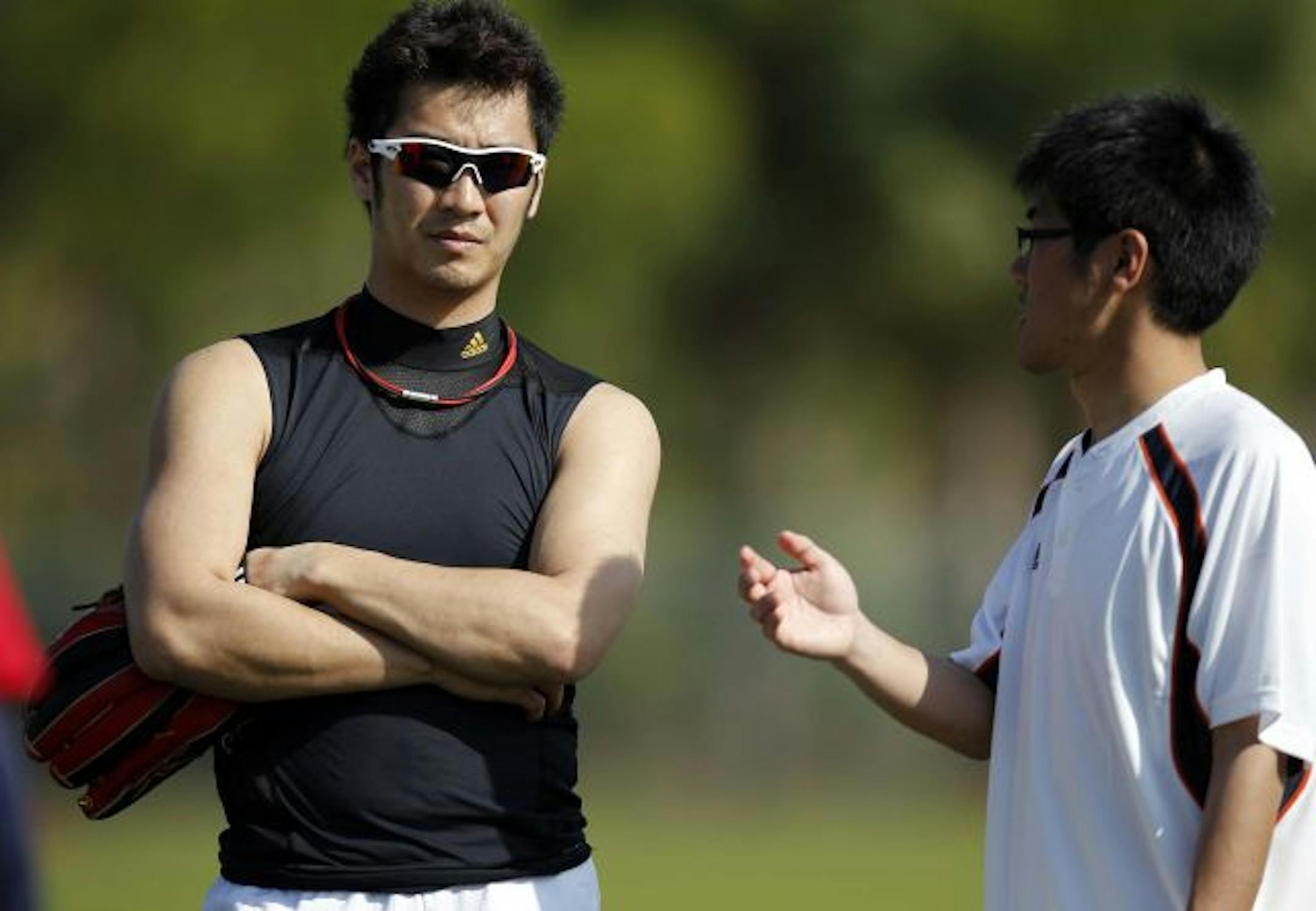 Twins infielder Tsuyoshi Nishioka heard the coaches instruction during drills from his interpreter Ryo Shinkawa during Thursday practice.