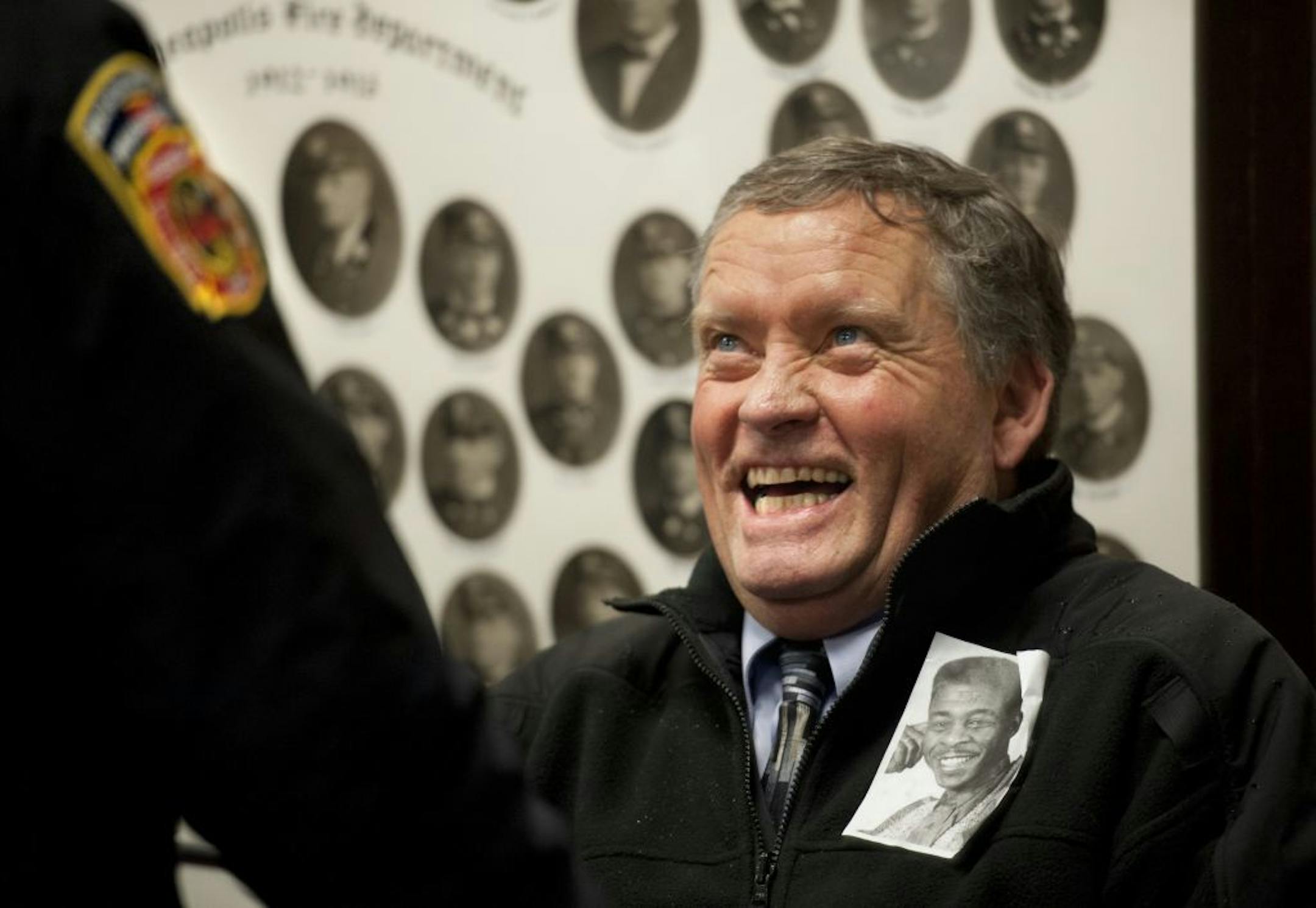 Incoming Minneapolis Fire Chief John Fruetel came to outgoing chief Alex Jackson's retirement party with a photo of his friend Alex on his jacket from when Jackson was an aspiring standup comic in his 20's. Friday January 27, 2012.