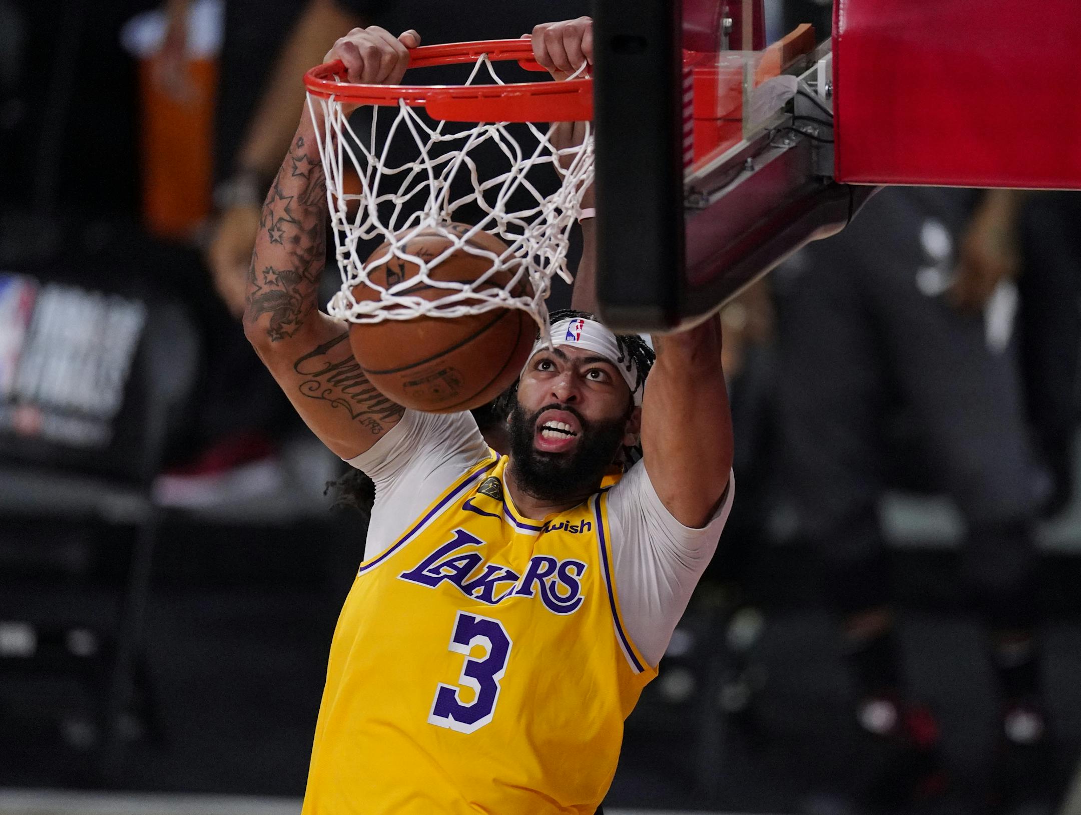 Los Angeles Lakers' Anthony Davis (3) slams a dunk against the Miami Heat during the second half of Game 1 of basketball's NBA Finals Wednesday, Sept. 30, 2020, in Lake Buena Vista, Fla. (AP Photo/Mark J. Terrill)