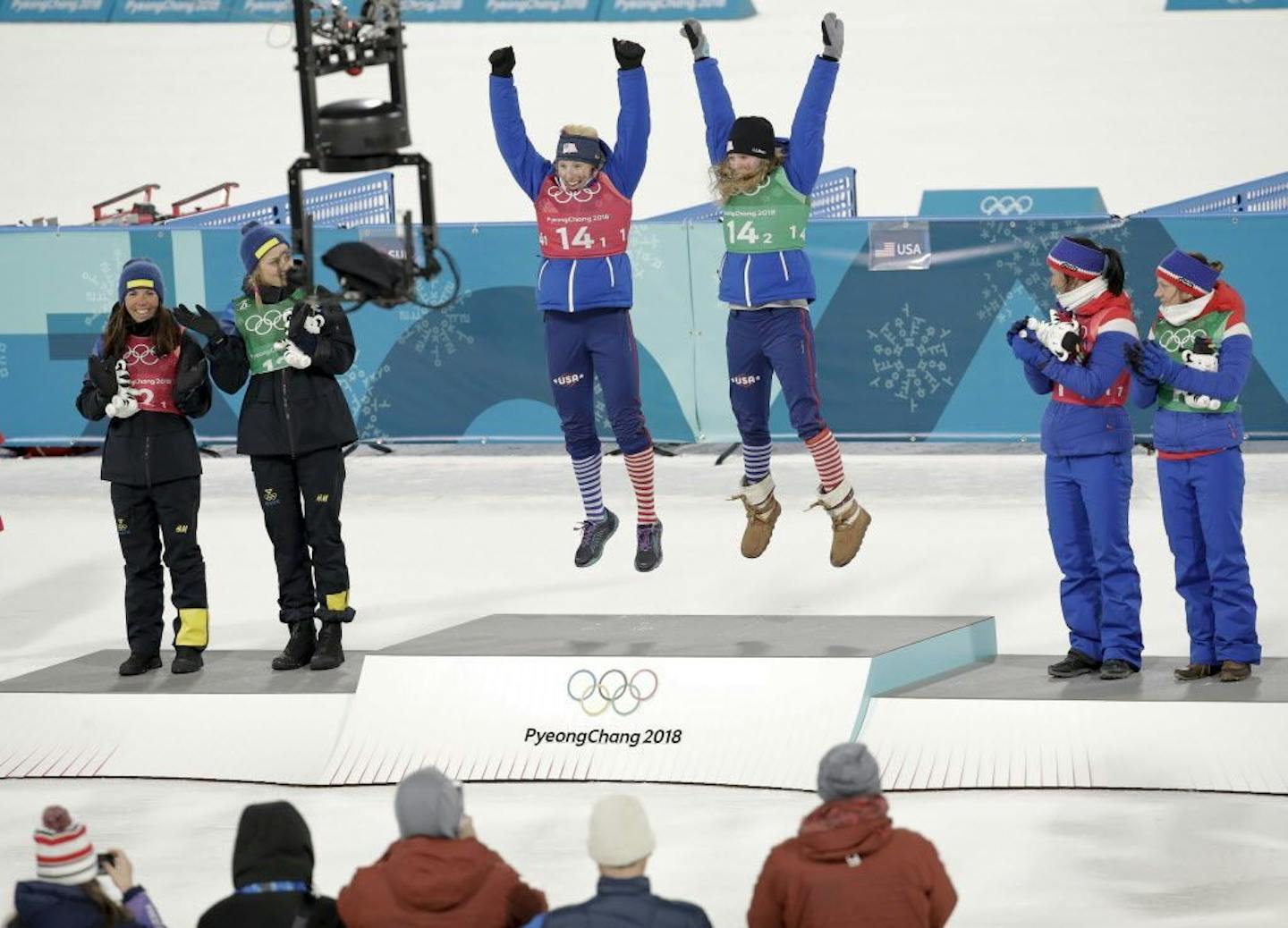 Gold medalists Kikkan Randall and Jessie Diggins jump for joy Wednesday after winning the women's team sprint freestyle cross-country skiing final at the 2018 Winter Olympics.