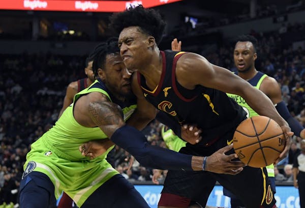 Minnesota Timberwolves' Robert Covington (33) reaches for the ball controlled by Cleveland Cavaliers' Collin Sexton (2) during the second quarter of a