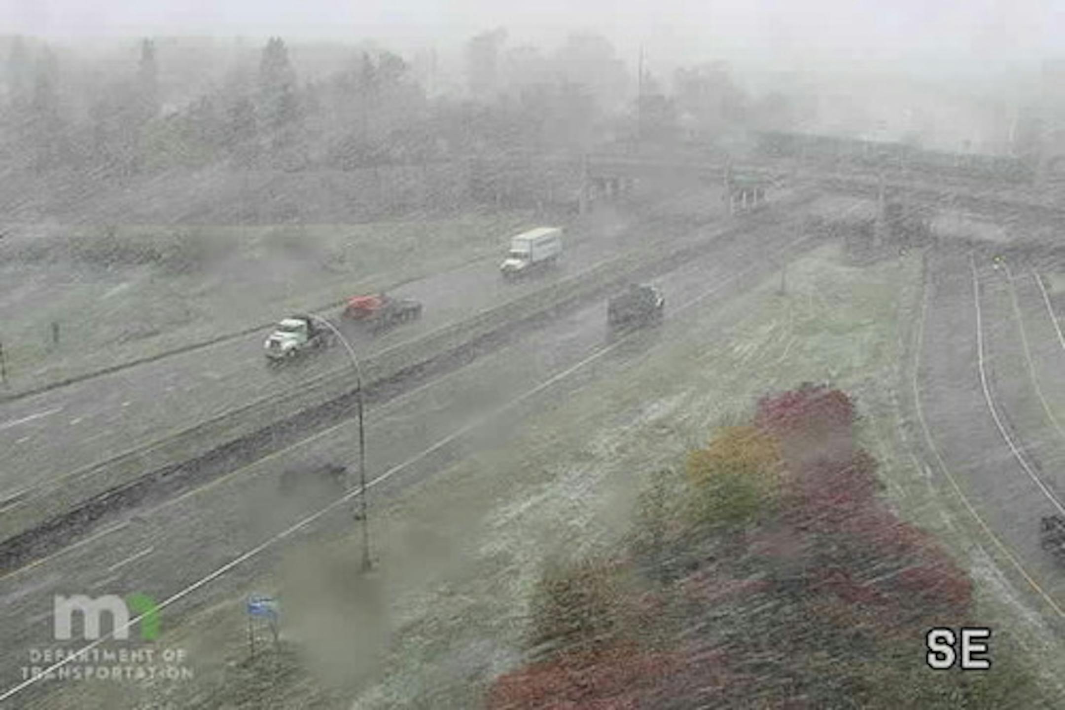 Motorists on Hwy. 100 in Robbinsdale drove through snow showers Friday morning, the first flakes of the season in metro area.