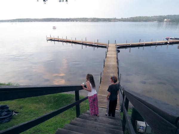 Kylie McClintick and new friend, Mitch Robertson of Mankato, check out the evening views of Gull Lake at Cragun's Resort before heading to the beach f