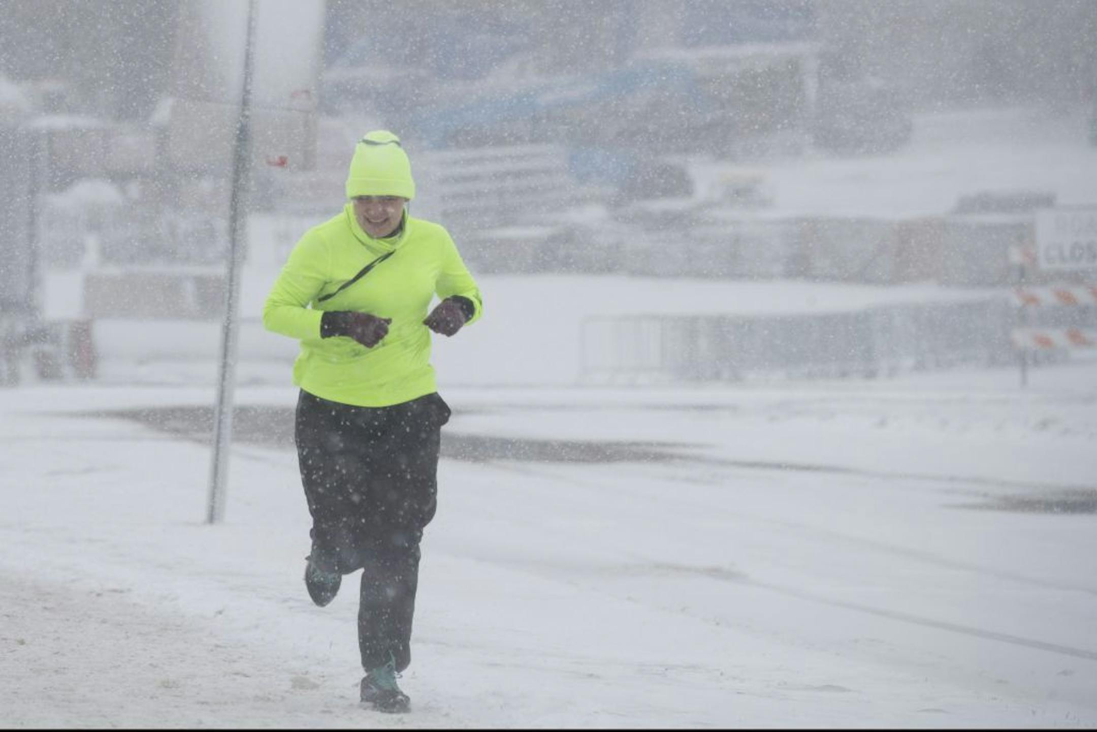 A runner braves the weather during a snow storm in St. Paul.