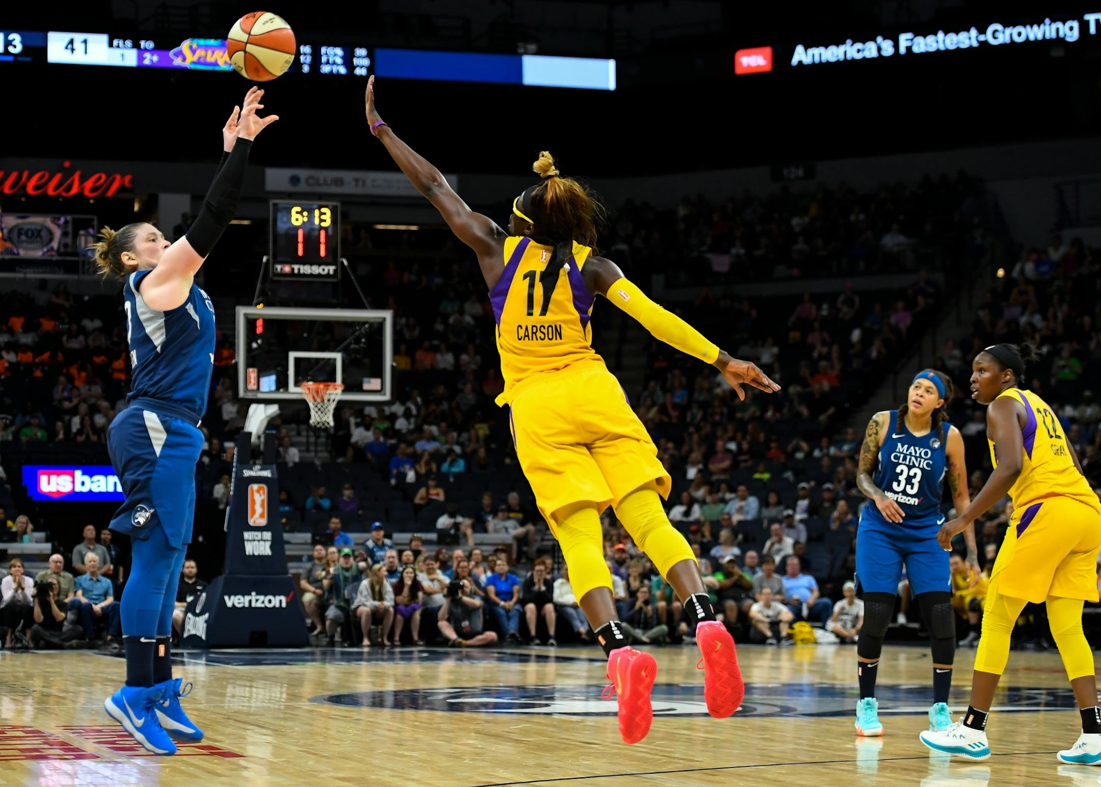 Minnesota Lynx guard Lindsay Whalen (13) hit a 3-pointer over Los Angeles Sparks forward Essence Carson (17) in the second half.
