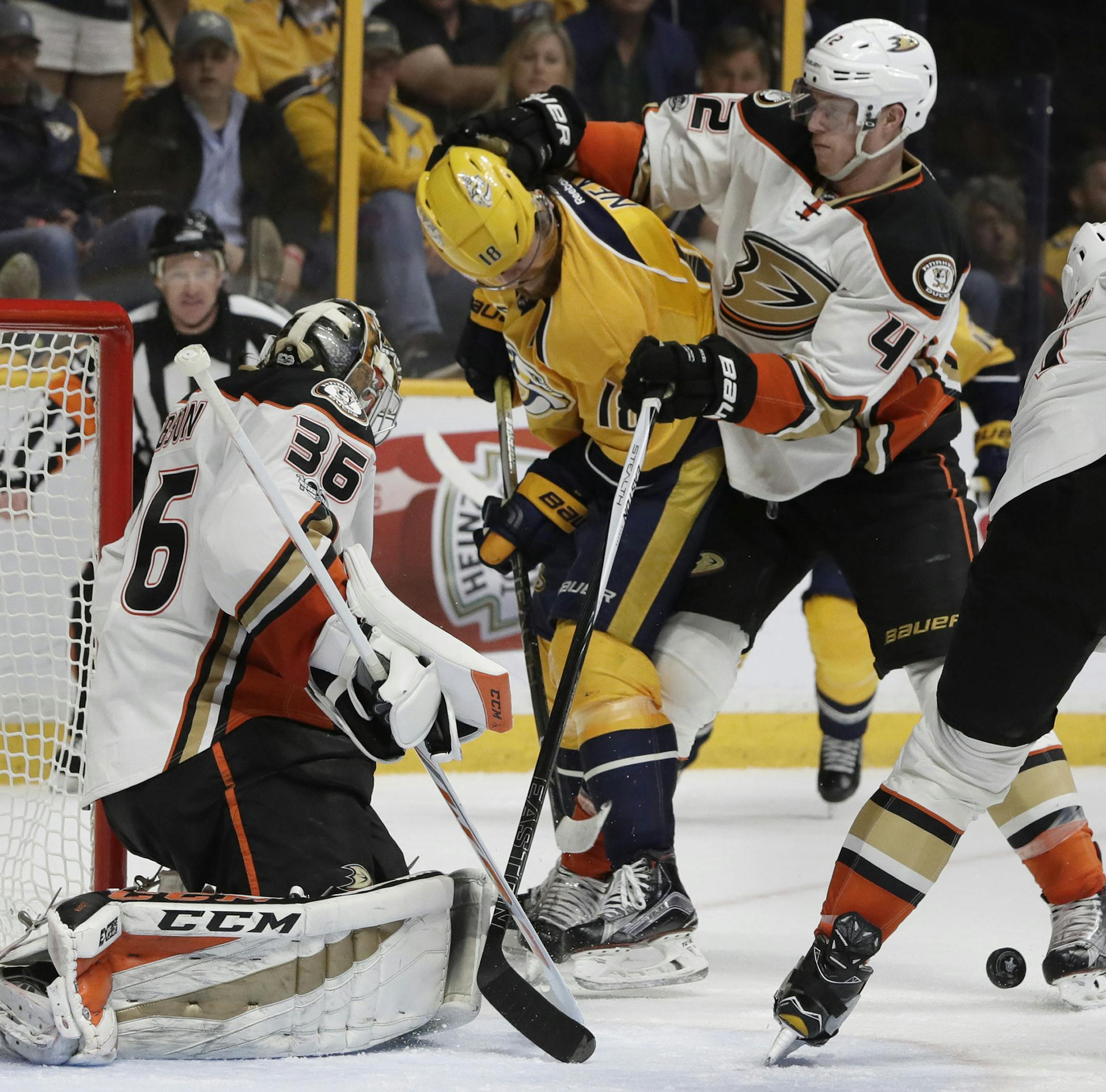 Anaheim Ducks goalie John Gibson (36), defenseman Josh Manson (42) and defenseman Cam Fowler (4) defend the net against Nashville Predators right wing James Neal (18) in the second period of Game 4 of the Western Conference final in the NHL hockey Stanley Cup playoffs Thursday, May 18, 2017, in Nashville, Tenn. (AP Photo/Mark Humphrey)
