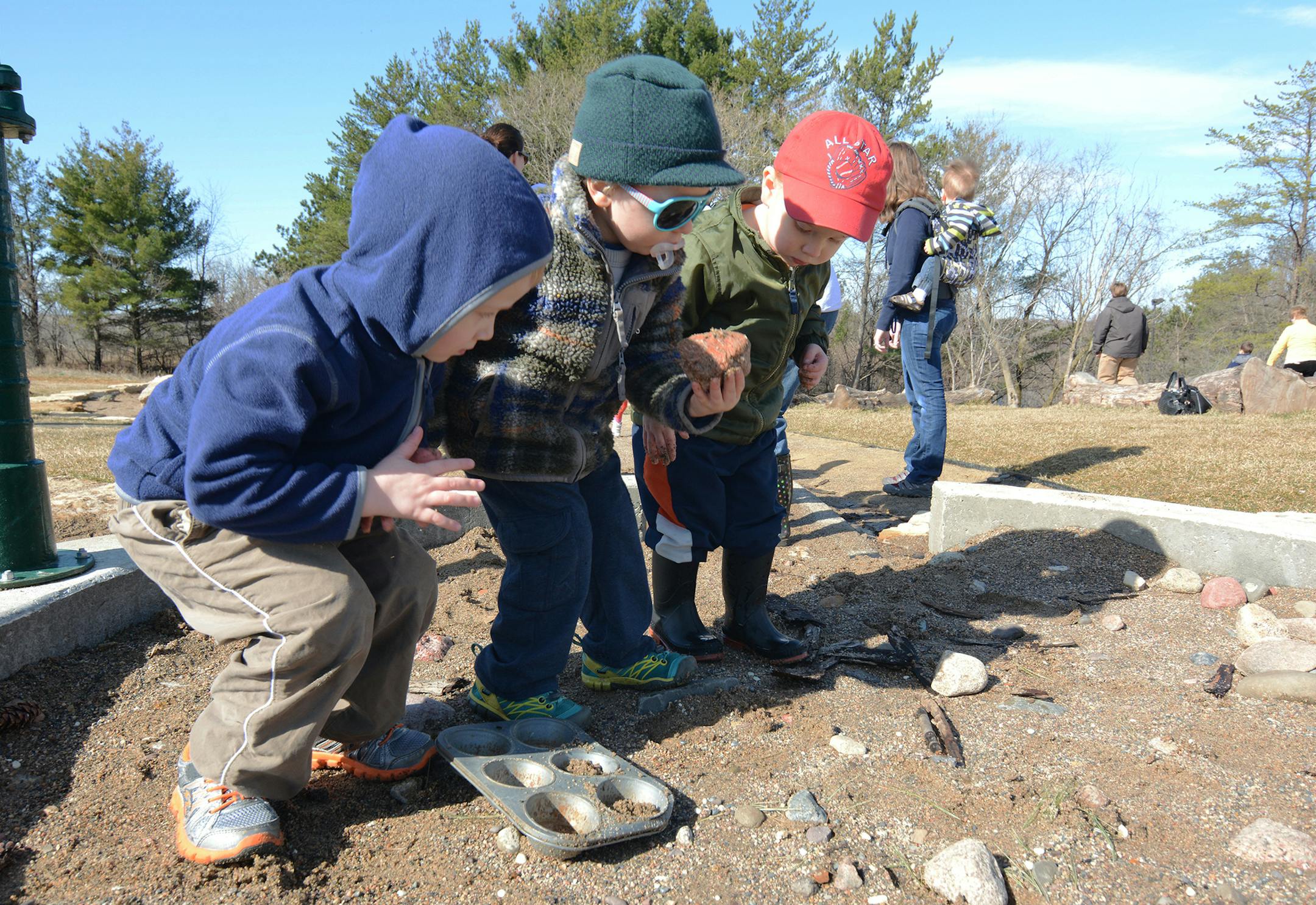 (left to right) Ryan Skibbe, 3, of Apple Valley, Eero Vondelinde, 3, of Rosemount, and Ethan Gillman, 2, of Apple Valley, played at in the sand area at Fawn Crossing. Photo by Liz Rolfsmeier, Special to the Star Tribune