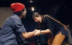 Annelyse Ahmad, in the central role of Leela, struggles with Owais Ahmed over a piece of fruit in Mixed Blood&#x2019;s production of &#x201c;Orange.&#