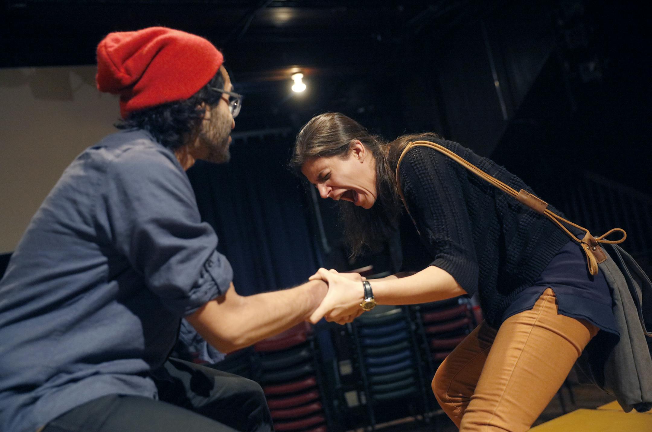 Annelyse Ahmad, in the central role of Leela, struggles with Owais Ahmed over a piece of fruit in Mixed Blood’s production of “Orange.”
