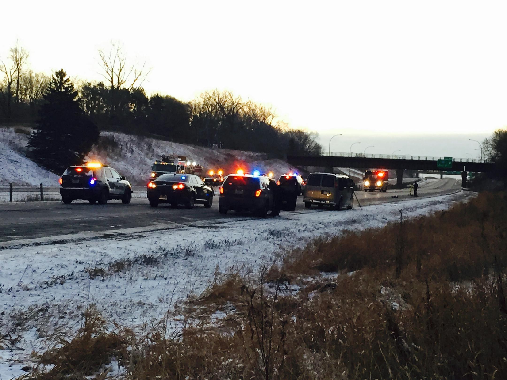 Authorities investigate the scene where officers shot and killed a murder suspect after a chase along I-694 in Shoreview.