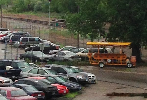 A pedal pub sits amid other vehicles at the Minneapolis impound lot.