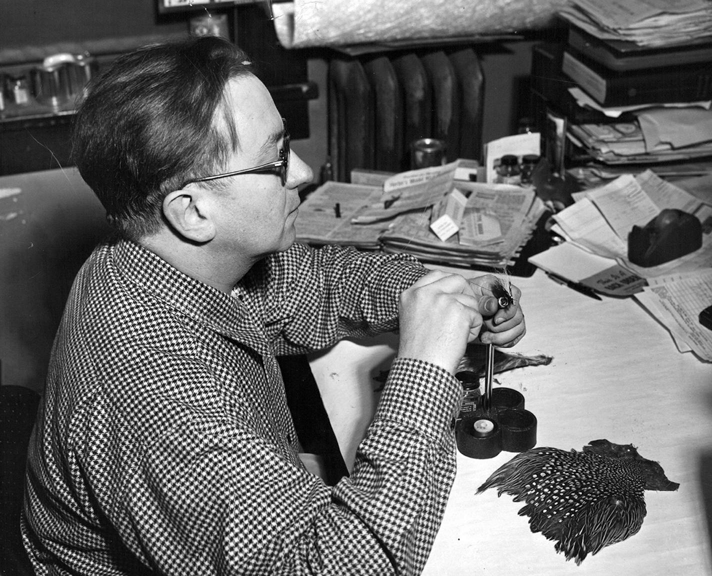 May 1, 1953 George L. Herter, president of Herter's, Inc., Waseca, Minn., sits down to tie himself a few flies for the trout season.