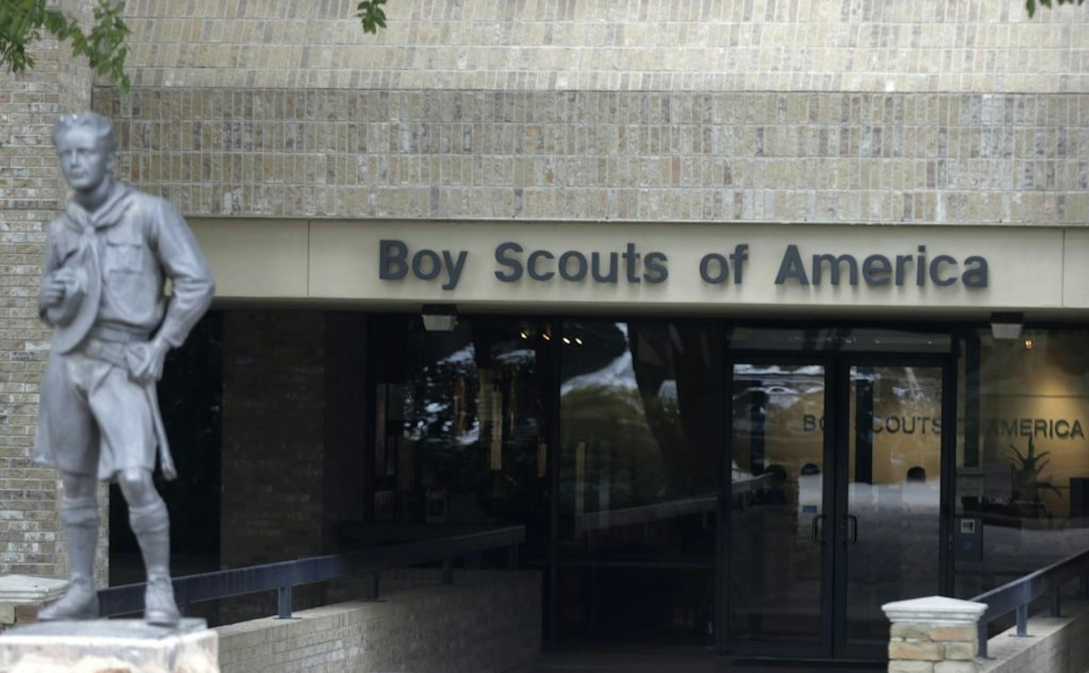 A statue of a Boy Scout stands in front of the Boy Scout of America Headquarters in Irving, Texas.