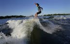 Bethany Anderson, 13, wake boards Friday on Lake Minnetonka in Orono, MN. The Anderson family is among a growing population that participate in the wa