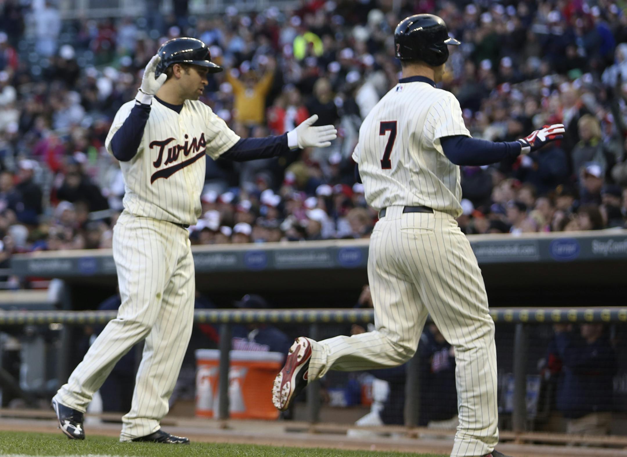 Twins Brian Dozier, left and Joe Mauer celebrated after crossing home plate in the fourth inning at Target Field in Minneapolis, Min., Saturday, May 11, 2013. ] (KYNDELL HARKNESS/STAR TRIBUNE) kyndell.harkness@startribune.com