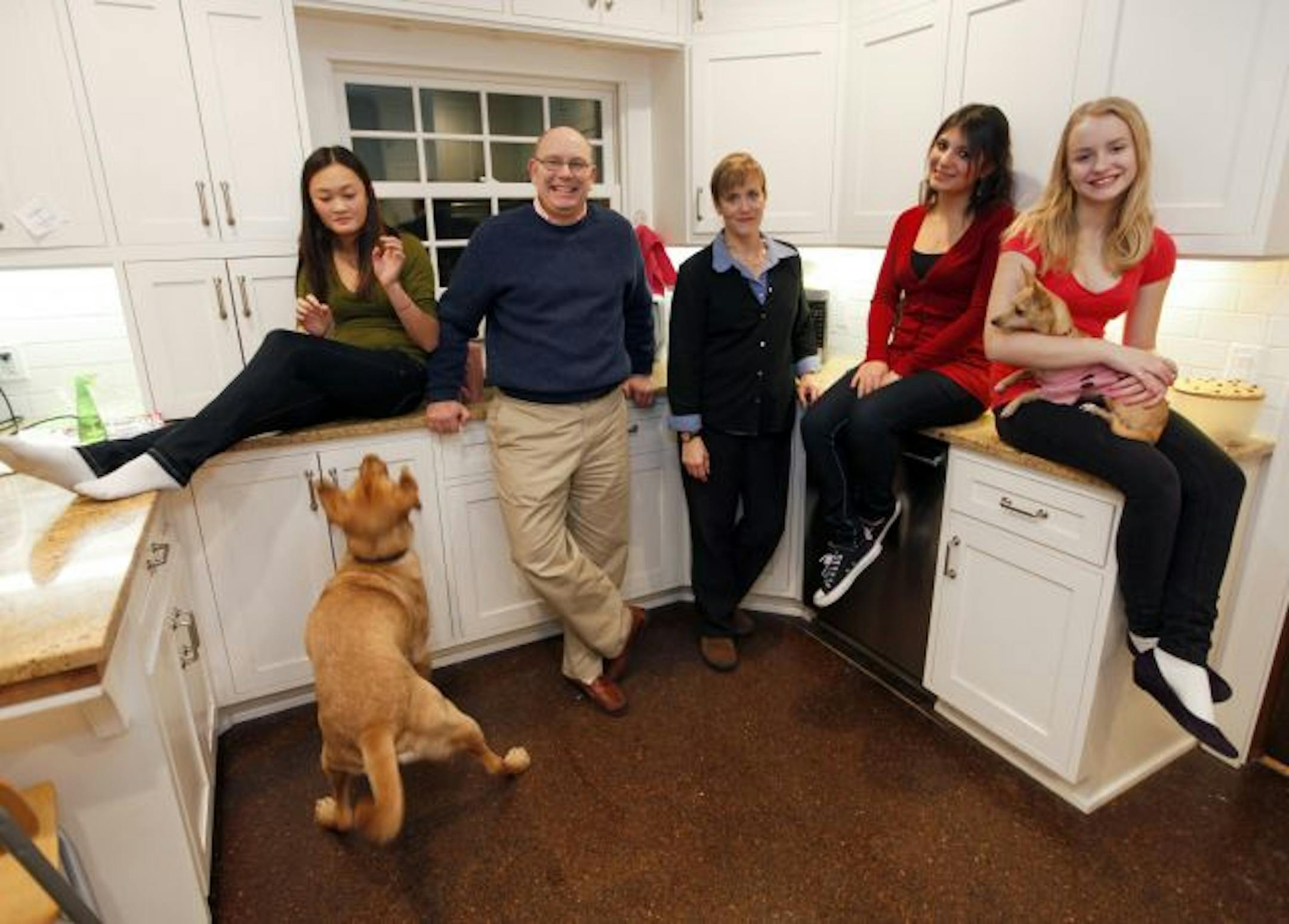 Delivering holiday meals is a family affair for the Fiala/Kendricks clan, from left, Emma Fiala, Dick Fiala, Julie Kendrick, exchange student Angie Castellano and Mary Katherine Fiala. The pooches are Boomer, looking for food, and Bambi.