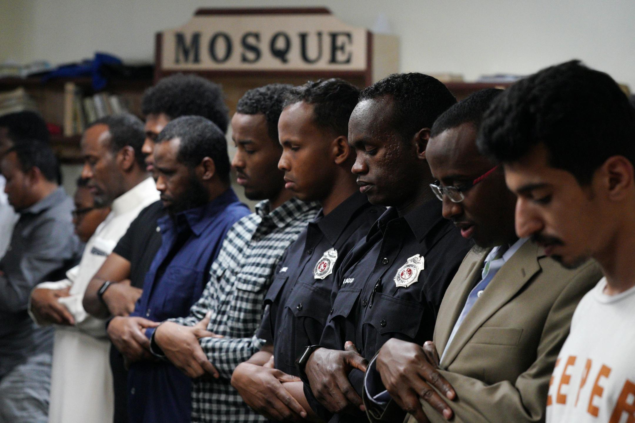 Abdi Warsame and Mohamed Daoud, two newly sworn in Somali American firefighters with the St. Paul Fire Department, prayed with worshipers at the Islamic Dawah Center as part of their community outreach.