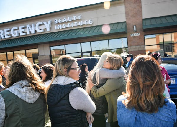 Students hugged and cried as they waited to collect their personal items from the Burnsville location of Regency Beauty Institute which abruptly close
