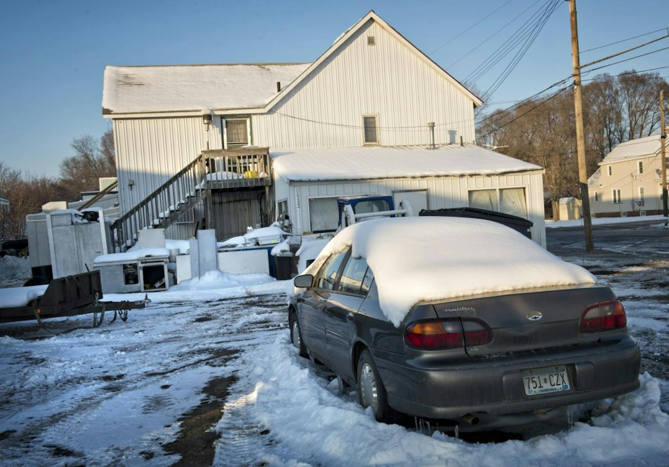 Ryan Larson's car was still parked Wednesday behind Winners Bar in Cold Spring, Minn., near where officer Thomas Decker was shot and killed last month. Larson, who lives in an apartment above the bar, remains the primary suspect, a source told the Star Tribune.