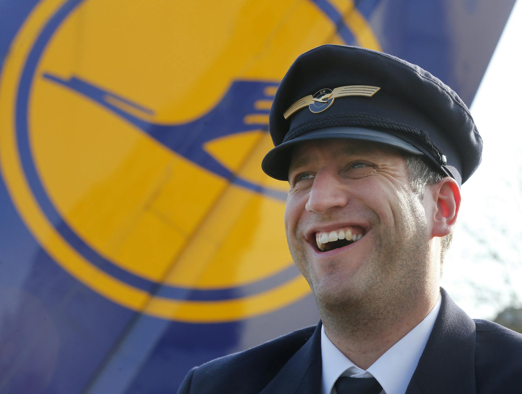 A pilot laughs as Lufthansa pilots went on a three-days-strike in Frankfurt, Germany, Wednesday, April 2, 2014. The pilots demand for higher wages while Lufthansa was forced to cancel 3800 flights during the strike.(AP Photo/Michael Probst) ORG XMIT: NYOTK