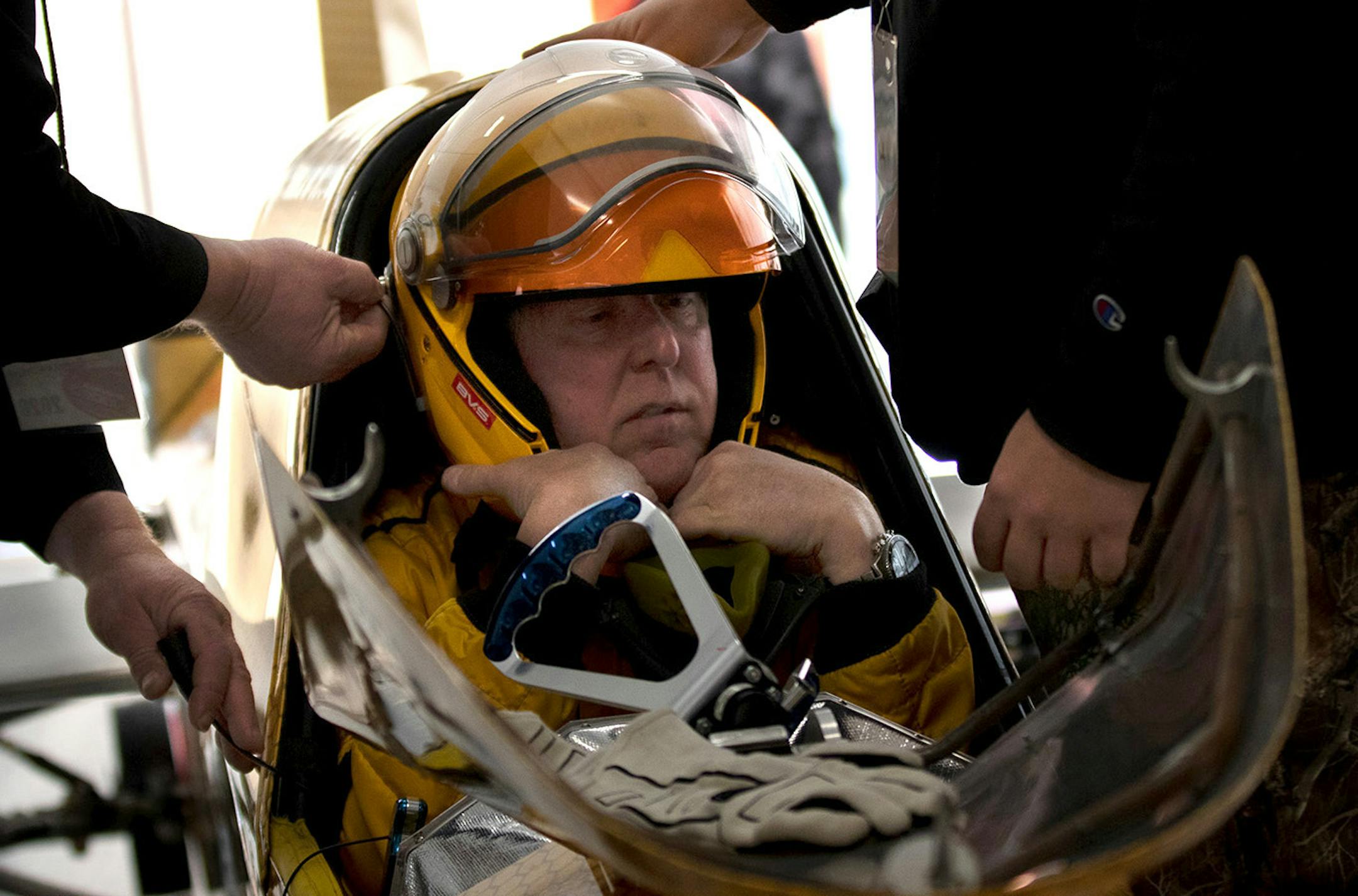The Rocketboys team help Kurt Anderson, the Arctic Arrow�s driver, into his helmet before his second run on Sunday, Feb. 16, 2020 on Bear Lake in Manawa, WI. When Anderson is fully suited, he fits so tightly in the seat that his head and body are held securely in place, adding an extra layer of safety to driving the Arrow.