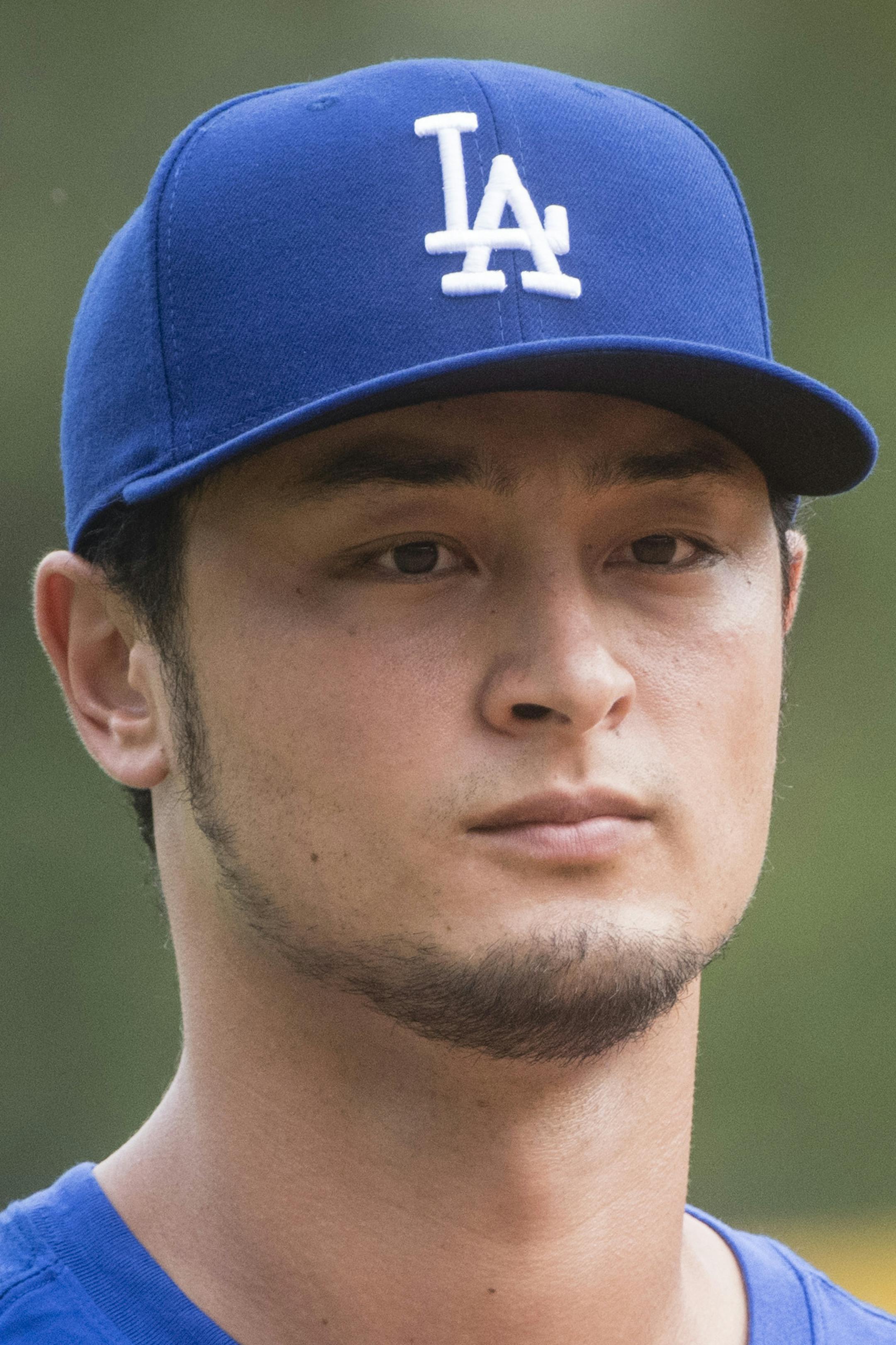 Los Angeles Dodgers' Yu Darvish comes off the filed after warm ups before a baseball game against the Atlanta Braves, Wednesday, August 2, 2017, in Atlanta. Darvish is a Japanese pitcher recently acquired from the Texas Rangers. (AP Photo/John Amis)