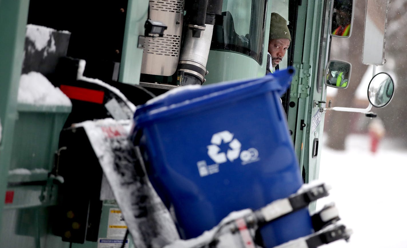 Driver Mourssalou Boukari made a recycling round early Wednesday, January 25, 2017 in St. Paul, MN. The first couple of weeks with new recycling trucks, 80,000 new recycling bins and new recycling pickup days has been frustrating for thousands of St. Paul residents. ] (ELIZABETH FLORES/STAR TRIBUNE) ELIZABETH FLORES &#x2022; eflores@startribune.com