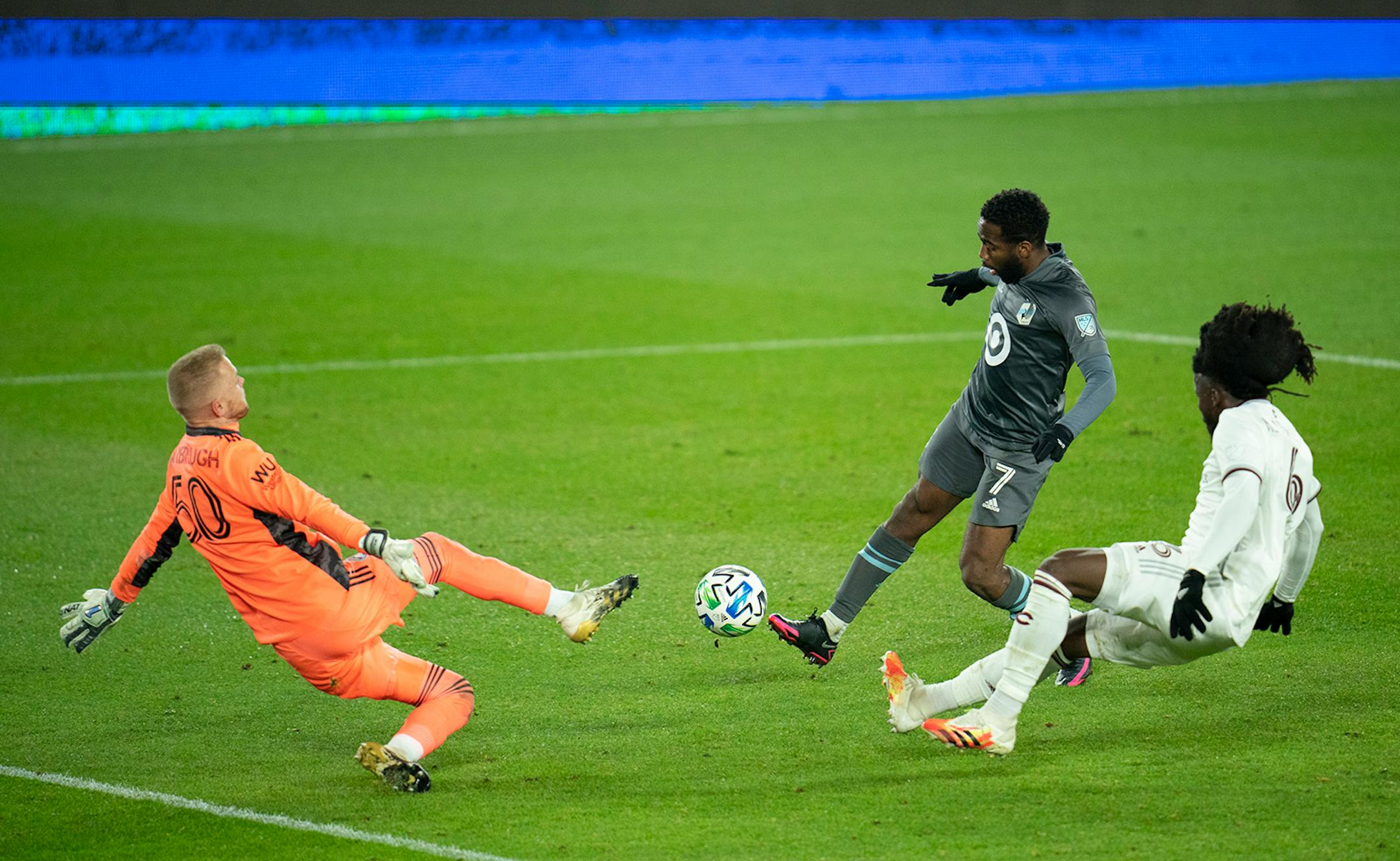 Minnesota United midfielder Kevin Molino (7) scored his second goal of the game with this shot over Colorado Rapids goalkeeper William Yarbrough (50) with Rapids defender Lalas Abubakar (6) coming late to defend.