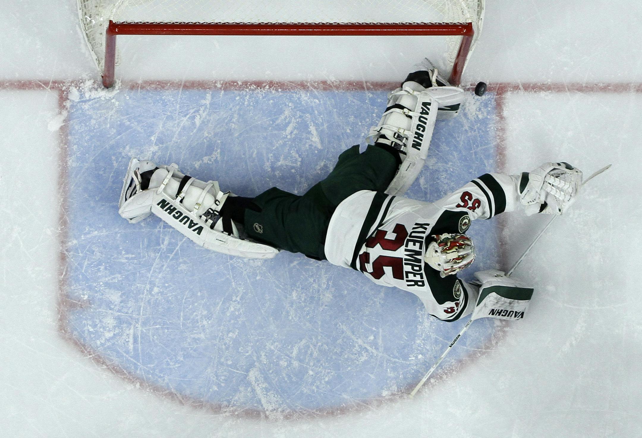 Minnesota Wild's Darcy Kuemper blocks a shot during the second period of an NHL hockey game against the Philadelphia Flyers, Thursday, Nov. 20, 2014, in Philadelphia. (AP Photo/Matt Slocum)