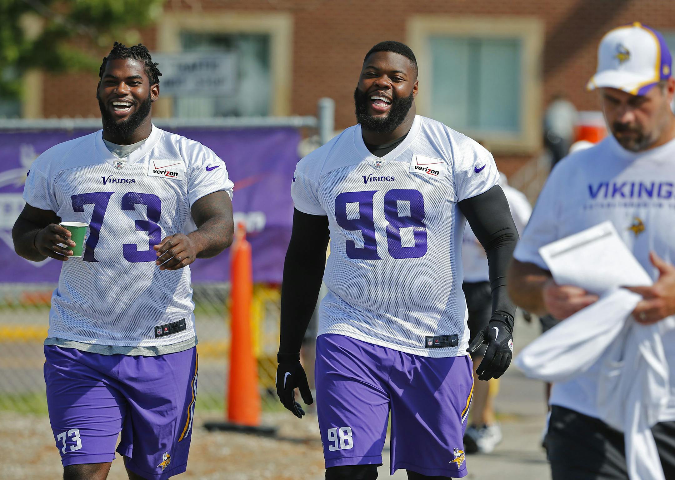 Minnesota Vikings defensive tackles Sharrif Floyd (73) and Linval Joseph (98) head to the field during the walk-through session of training camp Friday, July 24, 2014, at Mankato State University in Mankato, MN.] (DAVID JOLES/STARTRIBUNE) djoles@startribune Minnesota Vikings training camp Friday, July 24, 2014, in Mankato, MN.