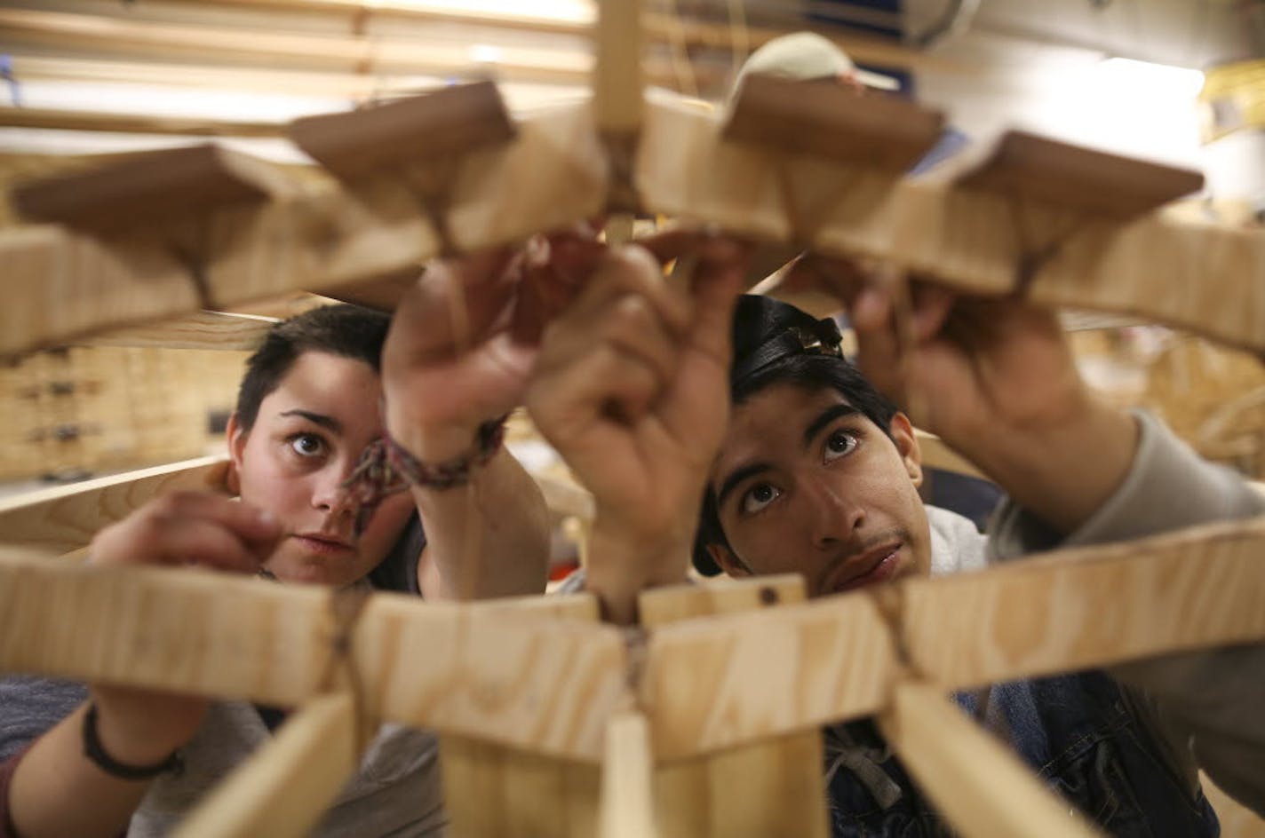 Lily Vraa and Joseph Romero lashed the floorboards to the frame of the kayak they were building at Urban Boatbuilders in St. Paul during a 2015 Give to the Max Day event.