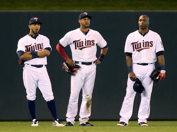 From left, Minnesota Twins left fielder Eddie Rosario (20), center fielder Aaron Hicks (32) and right fielder Torii Hunter (48) all looked on as relie