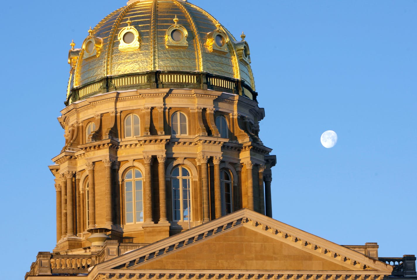 The moon hangs over the Iowa Capitol dome, Tuesday, Jan. 13, 2009, in Des Moines, Iowa. Gov. Chet Culver will focus largely on recovery efforts from last year's record flooding as he delivers his second report on the condition of the state to a joint session of the Legislature at the Capitol Tuesday. (AP Photo/Charlie Neibergall)