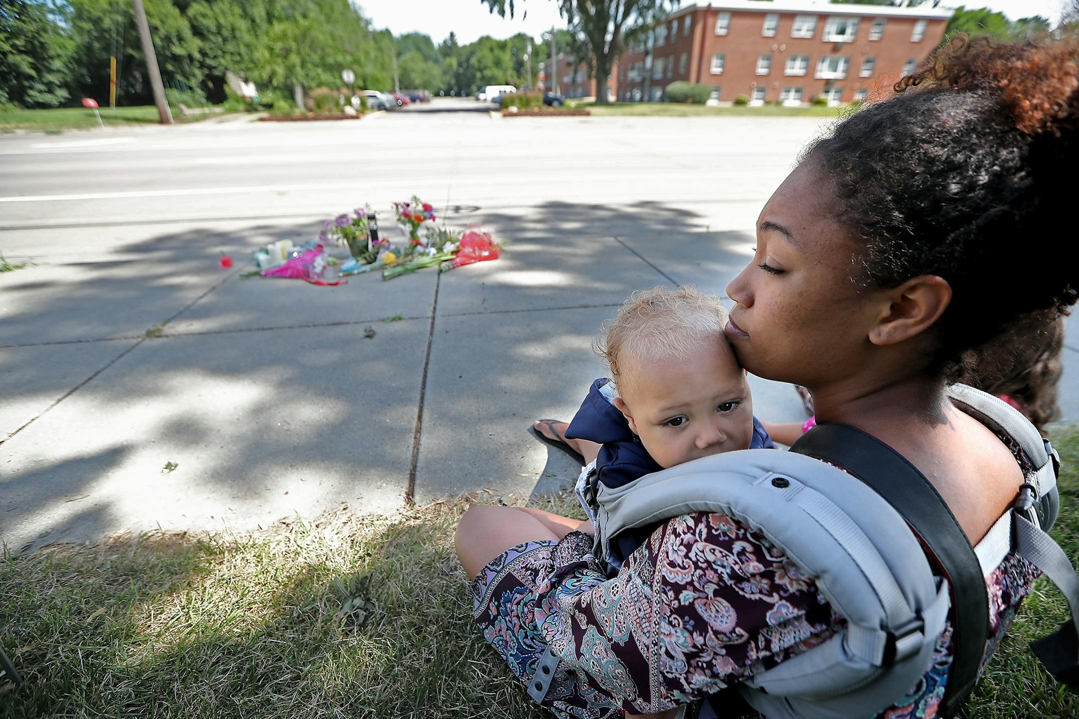 Gabriella Dunn held her son Oakland, 1, as she visited the scene where Philando Castile was shot by a police officer, Thursday, July 7, 2016 in Falcon Heights, MN. Dunn recalls being stopped by police and felt scared.