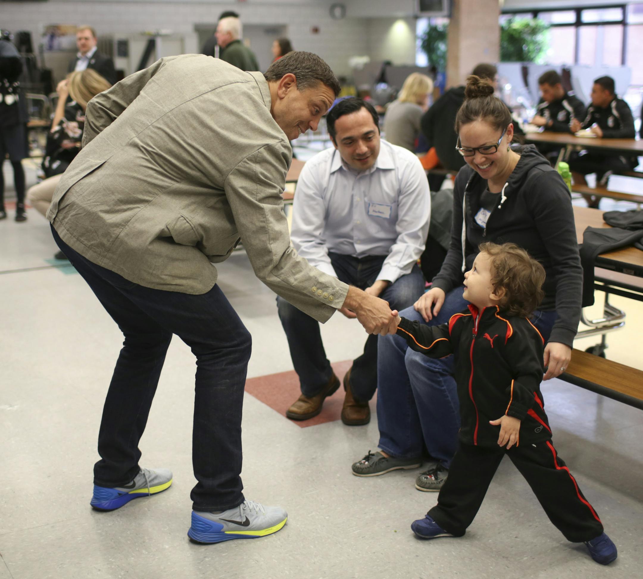Minnesota United FC head coach Manny Lagos shook hands with Felix Martinez while visiting with his parents, Everardo Martinez and Carly Miyamoto, season ticket holders who attended the potluck Tuesday night. ] JEFF WHEELER • jeff.wheeler@startribune.com Minnesota United FC sponsored a potluck for their season ticket holders ahead of their home opener this weekend. The event was held Tuesday night, April 21, 2015 at Roseville High School.
