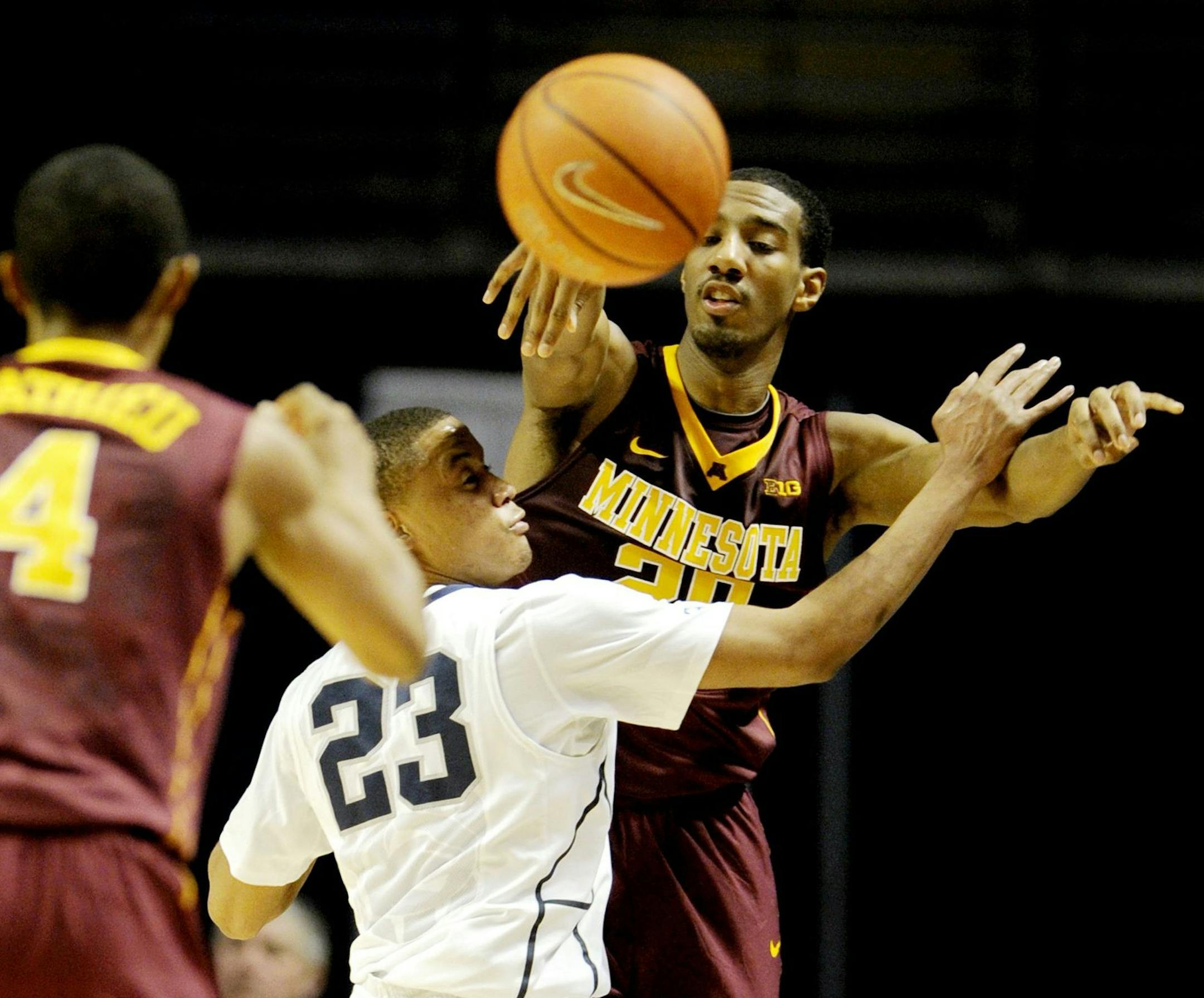 Minnesota's Austin Hollins passes the ball over Penn State's Tim Frazier at the Bryce Jordan Center in State College, Pa., on Wednesday, Jan. 8, 2014. The Minnesota Gophers defeated the Penn State nittany Lions, 68-65. (Abby Drey/Centre Daily Times/MCT) ORG XMIT: 1147665 ORG XMIT: MIN1401082137150115