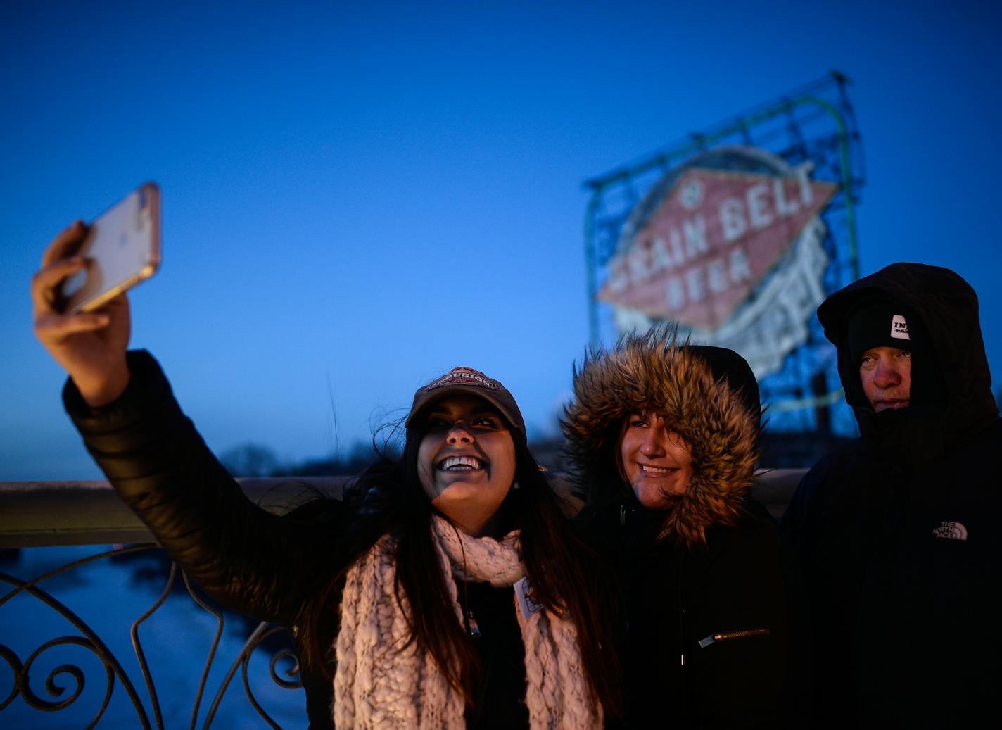 Abbie Porter, Paige Hendrickson and Bill Baburek took a selfie in front of the Grain Belt sign before its relighting ceremony Saturday night. ] AARON LAVINSKY &#xef; aaron.lavinsky@startribune.com A ceremony was held for the relighting of the Grain Belt sign in Minneapolis Saturday, Dec. 30, 2017. Revelers lined up along the Hennepin Bridge and along the Mississippi River.