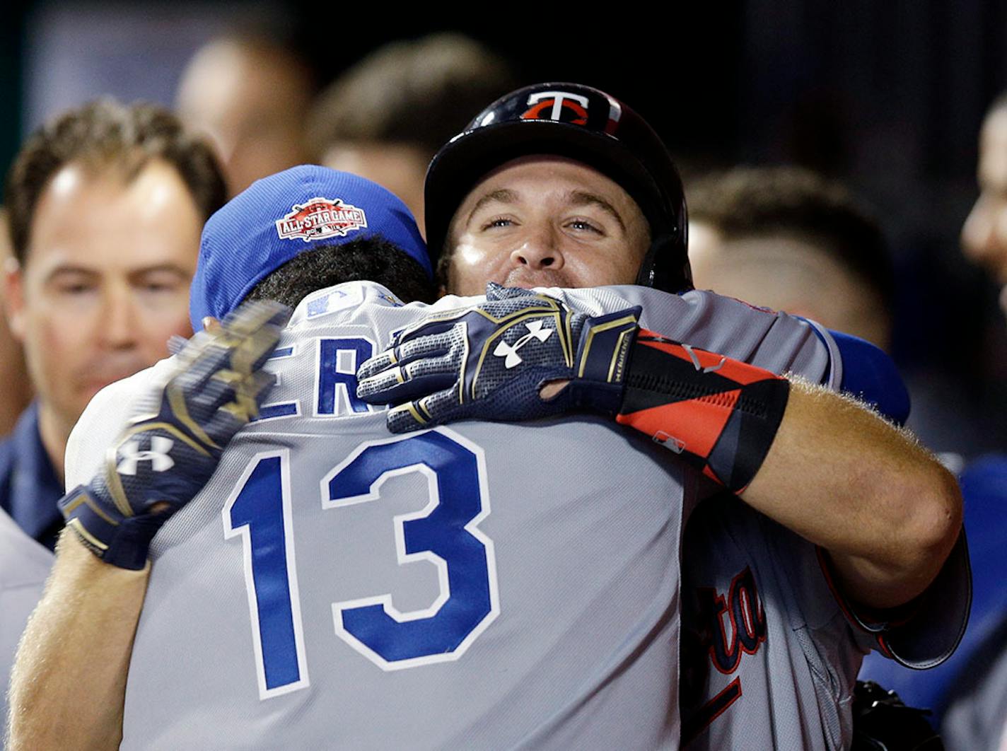 American League's Brian Dozier, of the Minnesota Twins, celebrates with American League's Salvador Perez, of the Kansas City Royals, after hitting a home run during the eighth inning of the MLB All-Star baseball game, Tuesday, July 14, 2015, in Cincinnati.