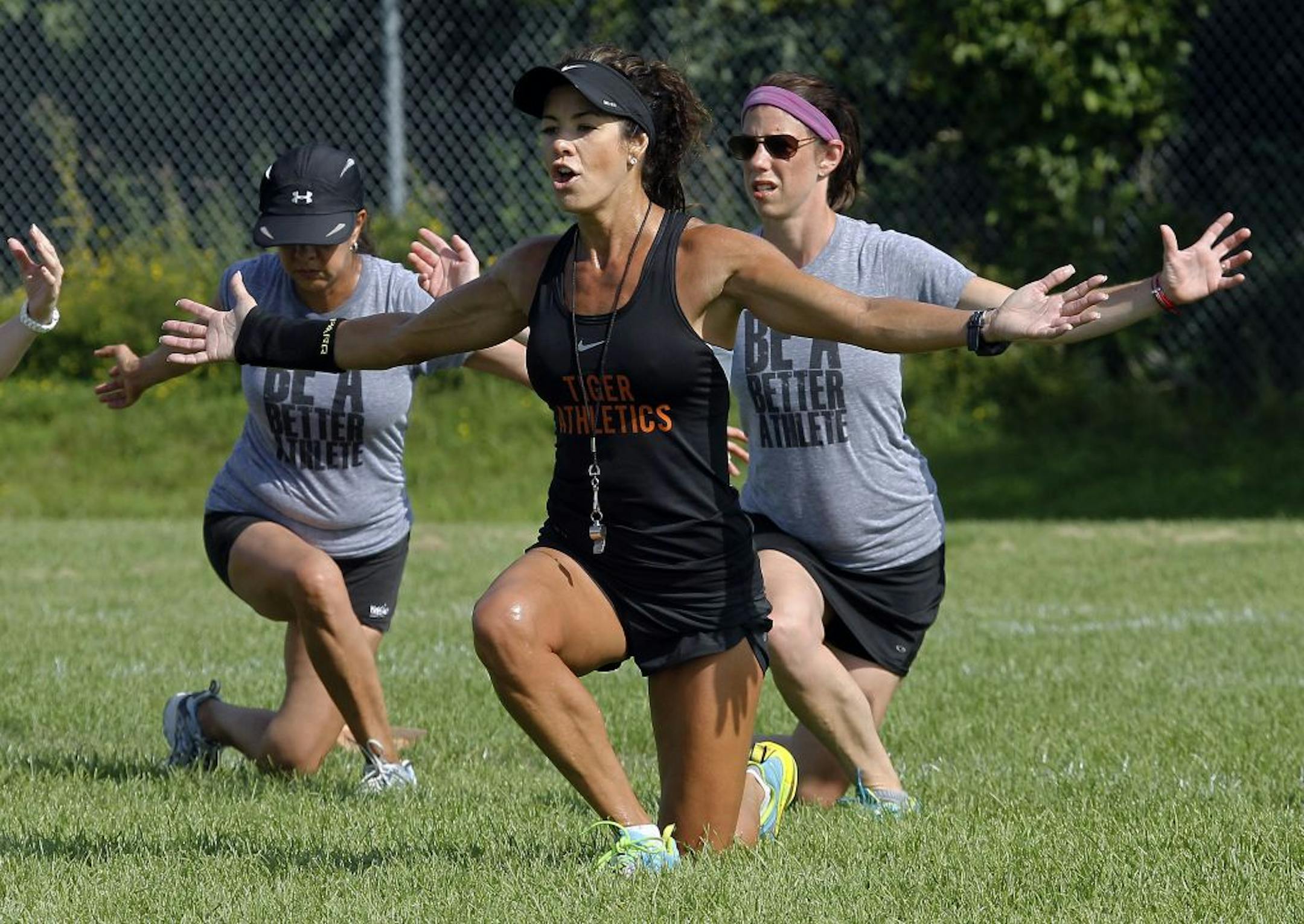 Stacie Clark led a workout for parents and children during a Tiger Athletics camp at the Bass Lake Playfield in Plymouth.