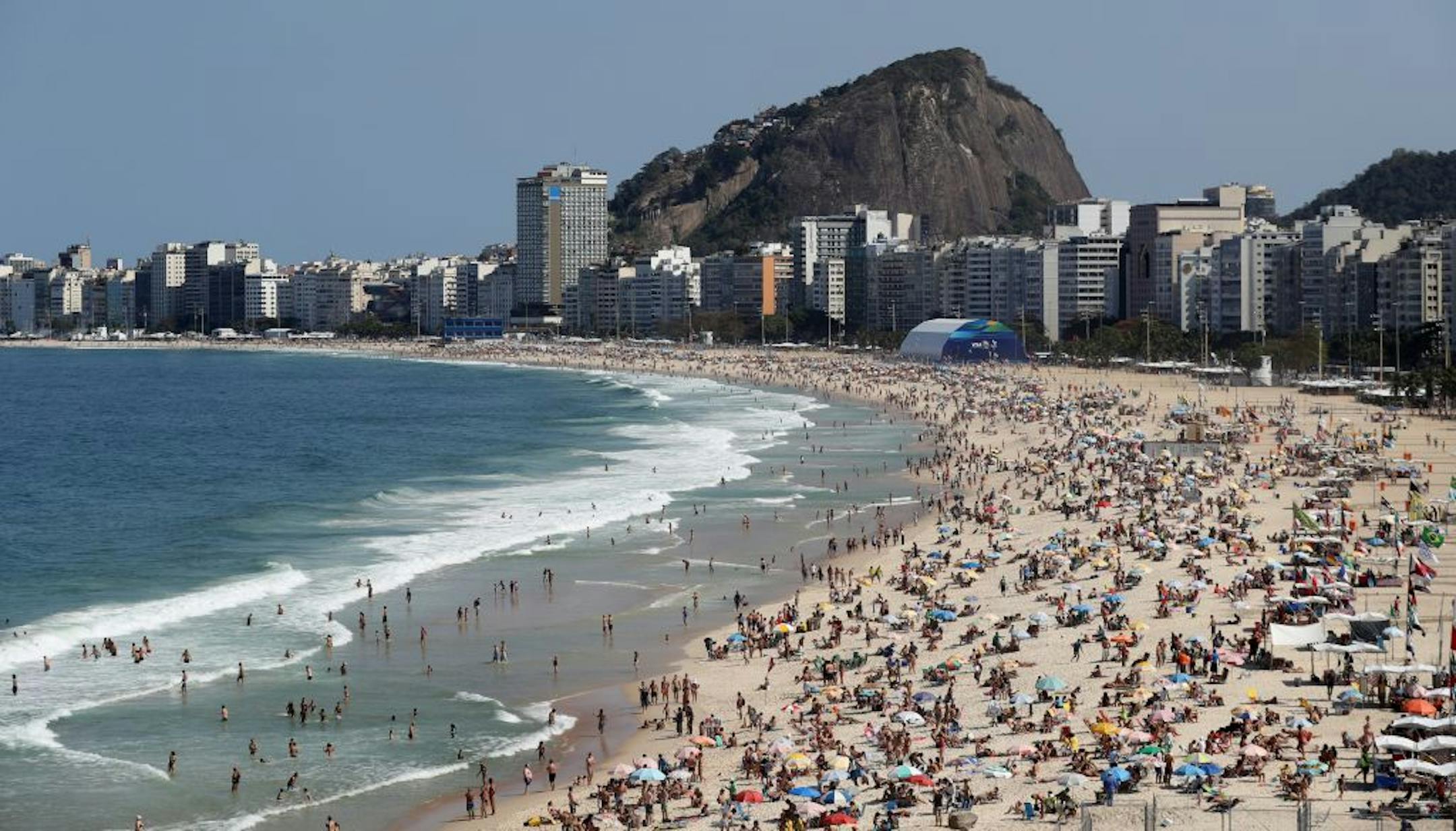 People enjoy a sunny day at the Copacabana beach prior to the 2016 Summer Olympics in Rio de Janeiro, Brazil, Friday, Aug. 5, 2016.