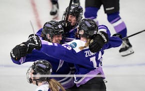 Frost forward Taylor Heise, left, is swarmed by teammates Britta Curl-Salemme and Grace Zumwinkle after she scored the winning goal in overtime Wednes