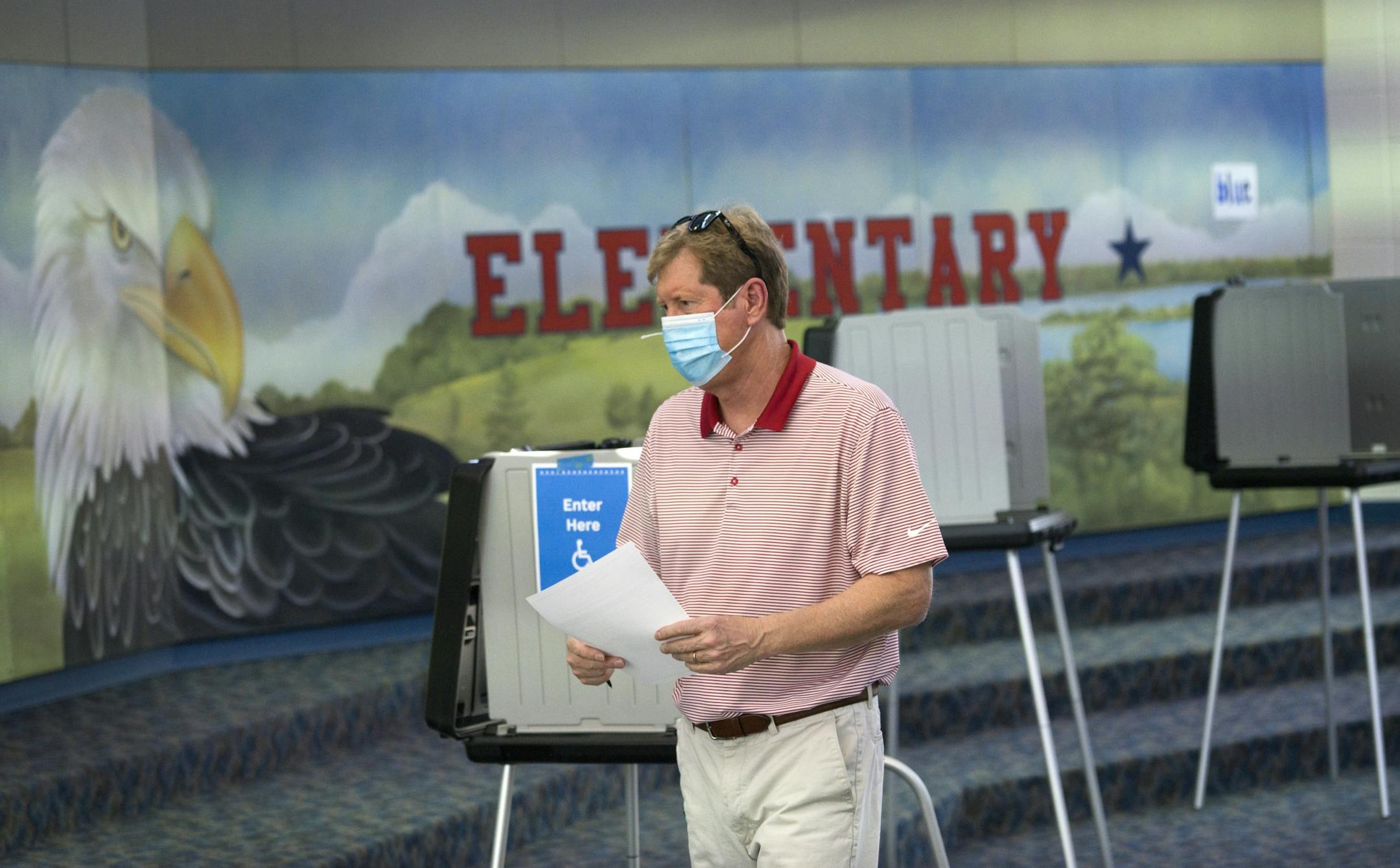 Jason Lewis cast his ballot at Liberty Ridge Elementary School in Woodbury Tuesday afternoon and slapped a "I voted" sticker on his chest after doing so.