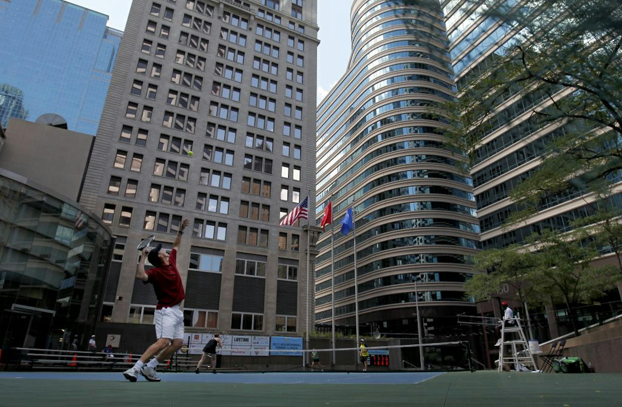 Aquatennial tennis, anyone? Doug Matuska prepared to serve during a doubles tennis match at the Lipton Tea & Honey Aquatennial Tennis Classic on Monday.