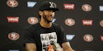 San Francisco 49ers quarterback Colin Kaepernick answers questions at a news conference after an NFL preseason football game against the Green Bay Pac