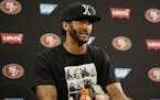 San Francisco 49ers quarterback Colin Kaepernick answers questions at a news conference after an NFL preseason football game against the Green Bay Pac