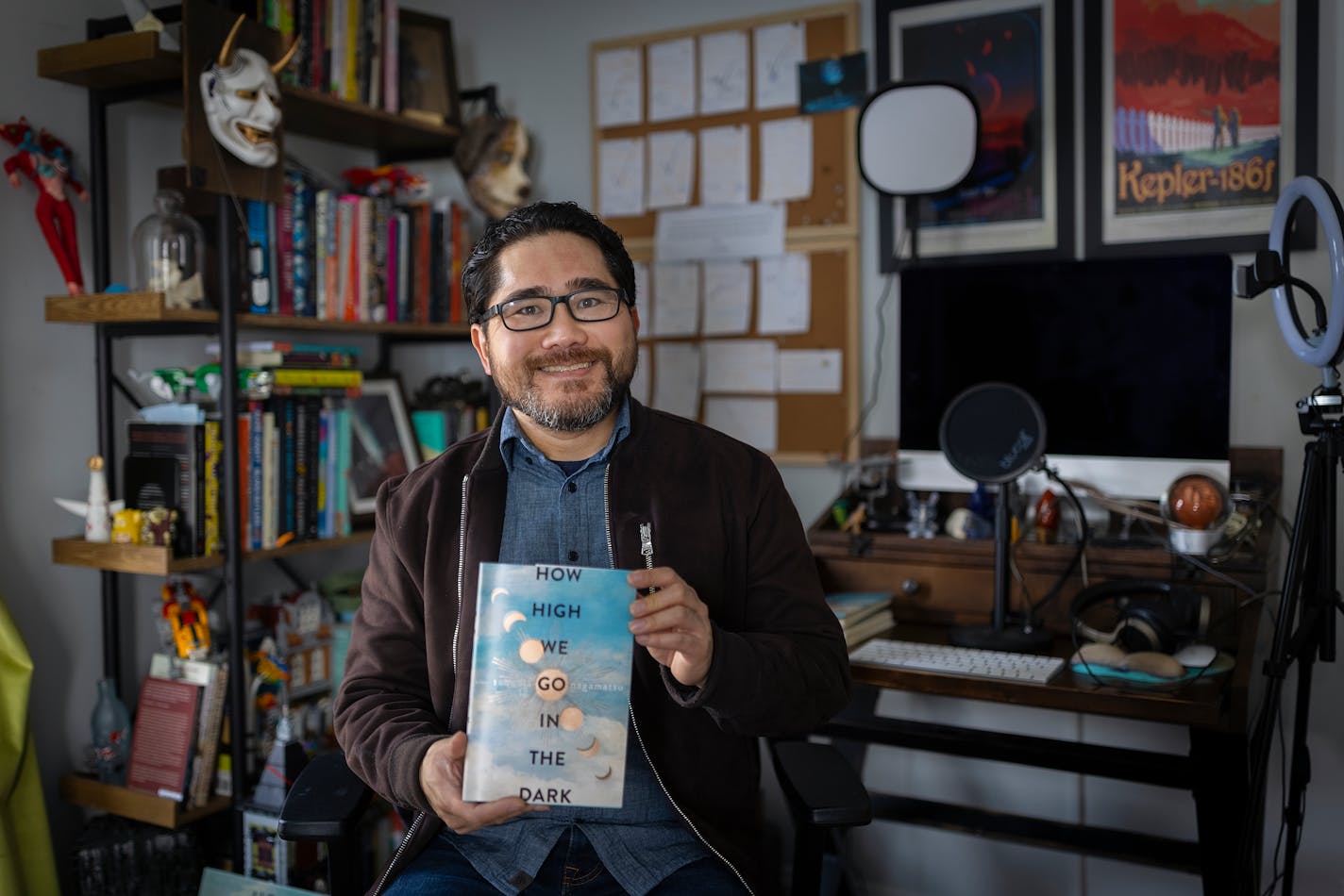 Minneapolis writer Sequoia Nagamatsu, whose new novel "How High We Go in the Dark" poses for a photo in the office where he wrote it, Friday, Jan. 7, 2022 at his home in Minneapolis, Minn. The book will be published on Jan. 18. It is his first novel. It's about an ancient virus that is released into the world when climate change causes the permafrost to melt. He started writing it 10 years before COVID. ] Elizabeth Flores • liz.flores@startribune.com