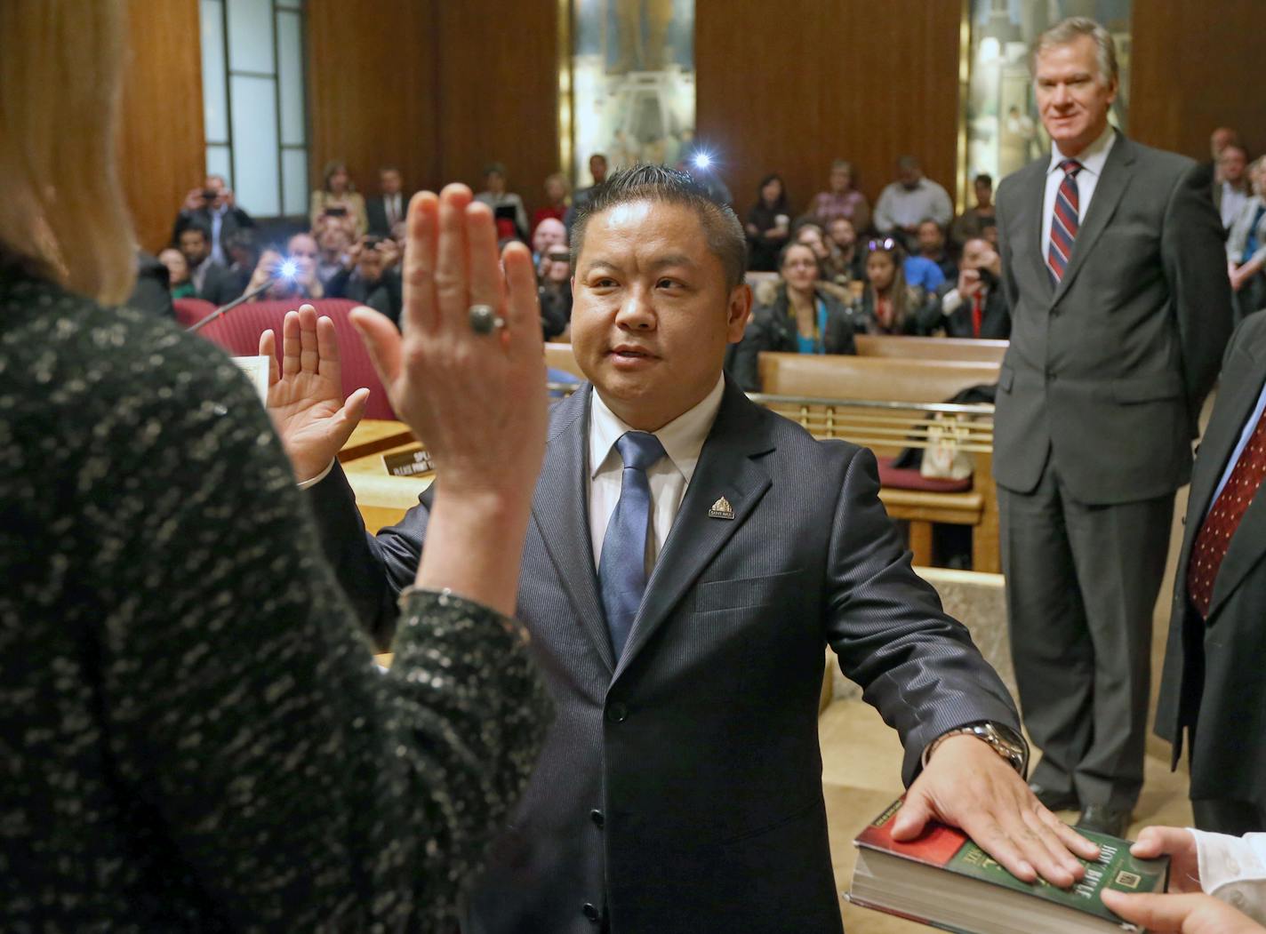 St. Paul City Clerk Shari Moore swore in Dai Thao, the first Hmong-American to be elected to the St. Paul City Council, as Mayor Chris Coleman, fellow council members, family and friends watched.